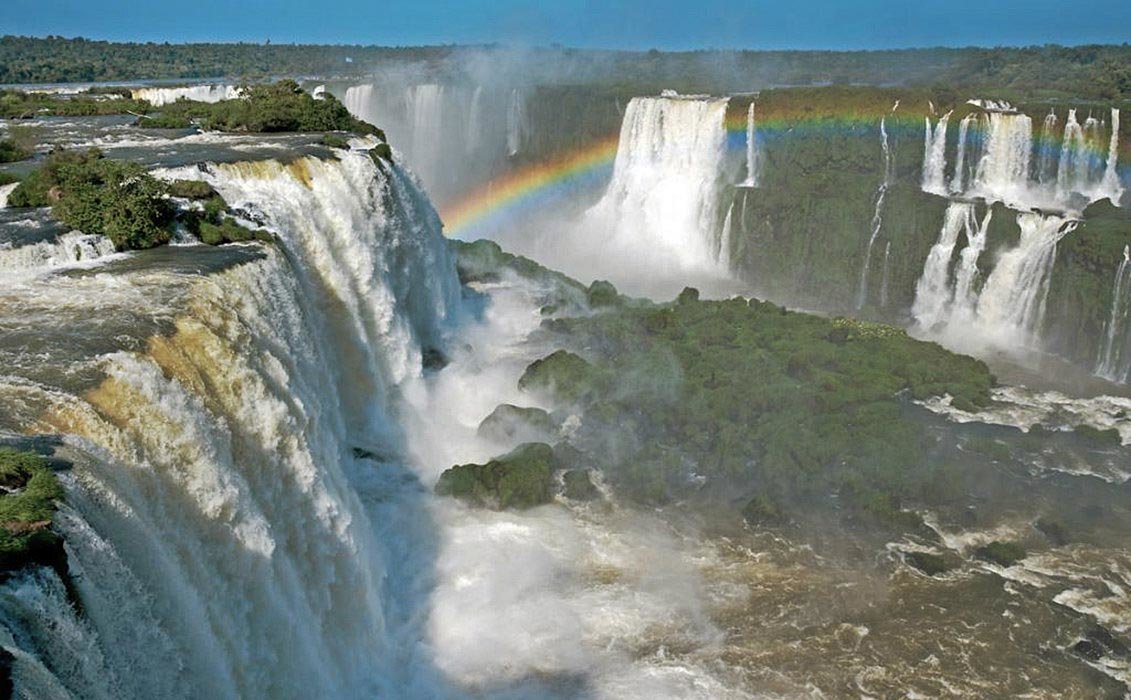 On sunny days, colorful rainbows are formed by the ascending mist